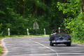 Jaguar XK150 Roadster noir forêt face arrière