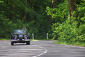 Jaguar XK150 Roadster noir forêt face avant