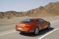 Bentley Continental GT orange 3/4 arrière droit travelling