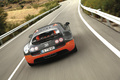 Bugatti Veyron Super Sport noir/orange face arrière travelling penché vue de haut
