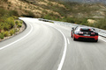 Bugatti Veyron Super Sport noir/orange face arrière travelling penché