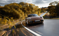 Porsche 991 Carrera 4 marron face avant travelling penché