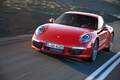 Porsche 991 Carrera rouge 3/4 avant gauche travelling penché