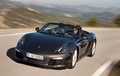 Porsche Boxster - marron - 3/4 avant gauche, dynamique